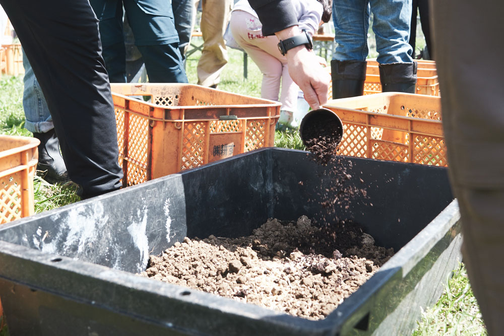 泥包み焼き用の土と同じ土を用意。「このままでは栽培には向かないですね。野菜作りに適した土になるように、籾殻、粉々にした笹、堆肥を混ぜてください。混ぜる量は自分たちで考えて」と伊藤さん。