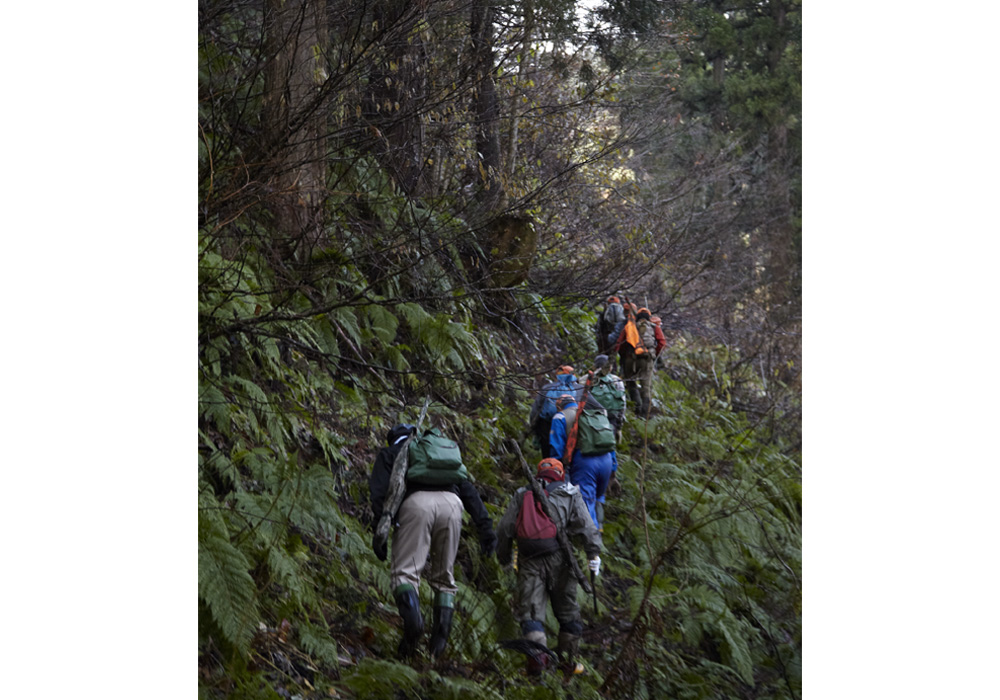 道なき斜面を上がっていくマタギ